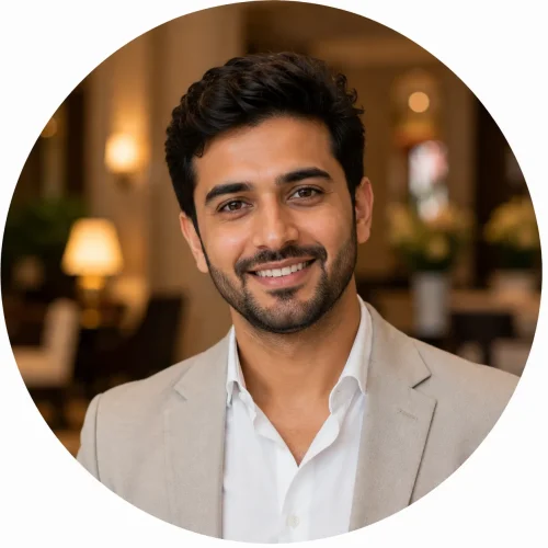 Smiling male hotel guest portrait wearing a light blazer, ideal for a luxury hotel testimonial profile with a warm and welcoming atmosphere.